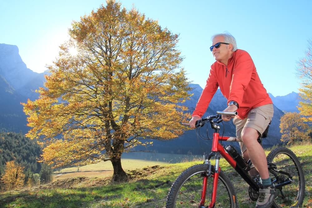 senior riding a bike for heart health