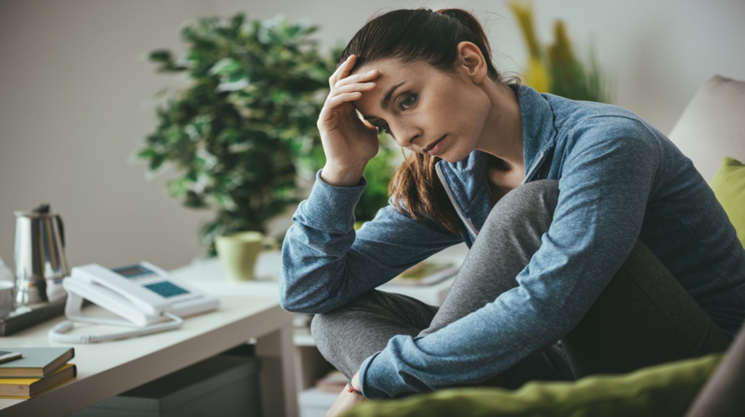 woman dealing with feelings of depression at home