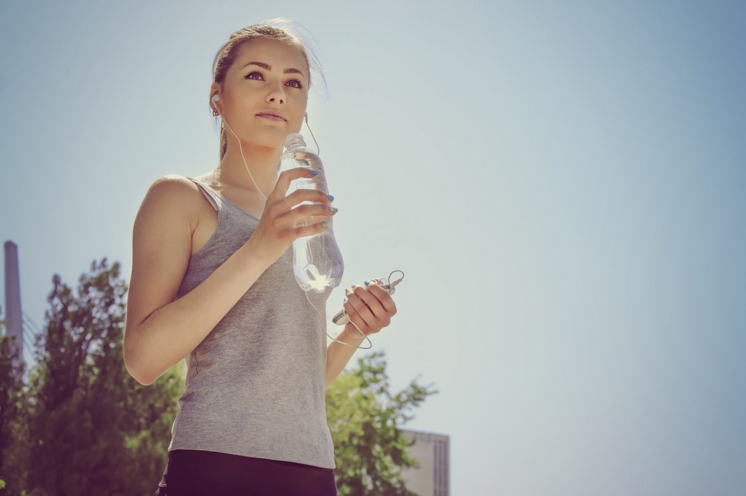 jogger performing the healthy habit of drinking water